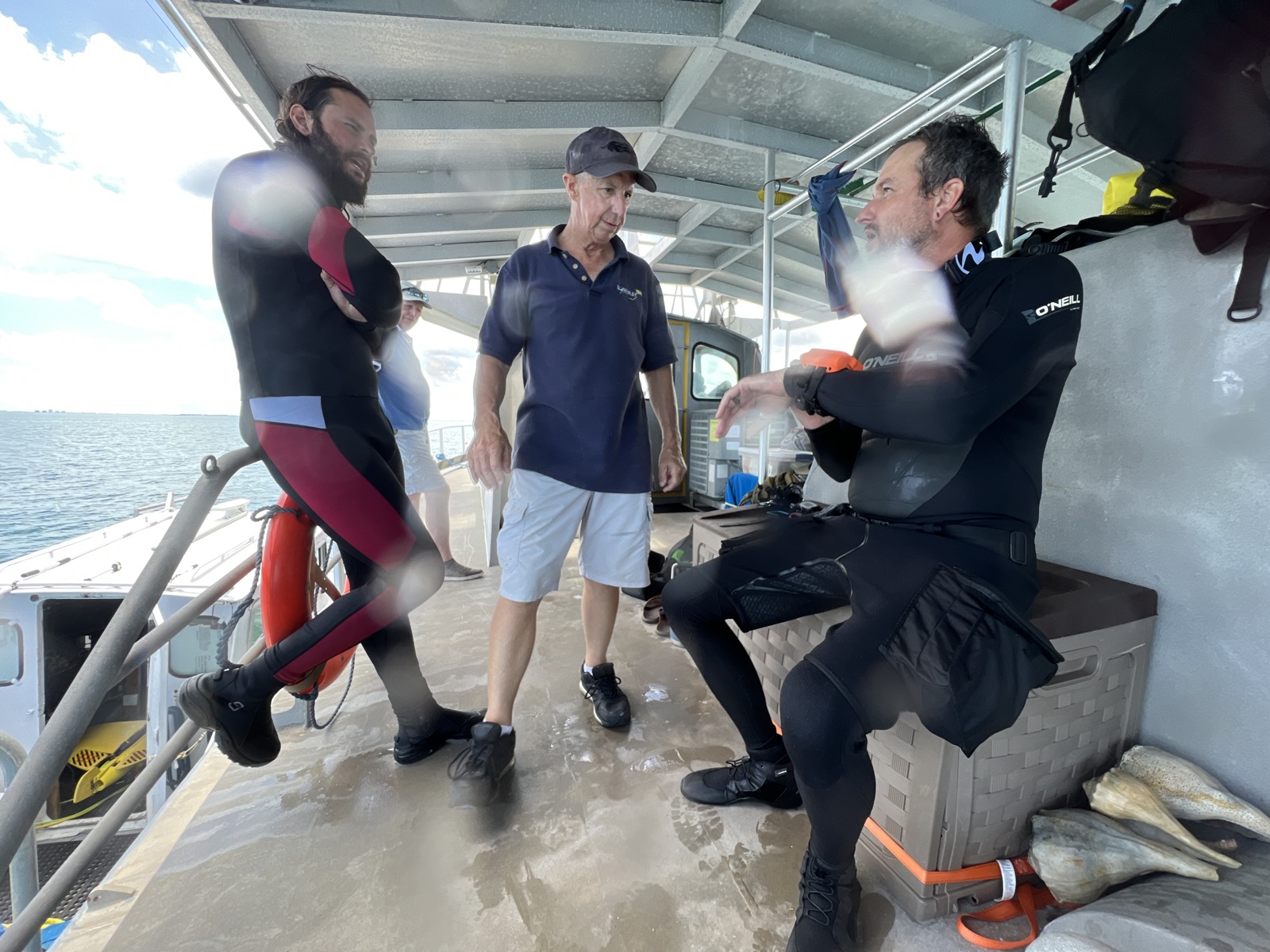 Divers and crew on the deck of the salvage vessel